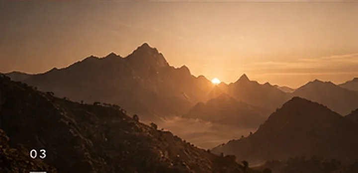 Sunrise over misty mountains